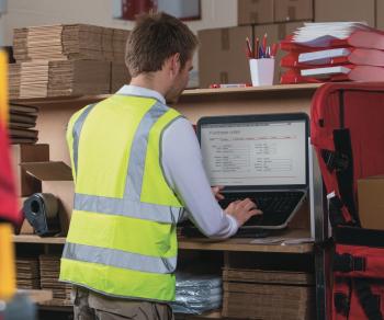 Man receiving an order in a warehouse on a computer screen