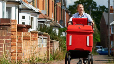 Postie delivering mail with a trolley